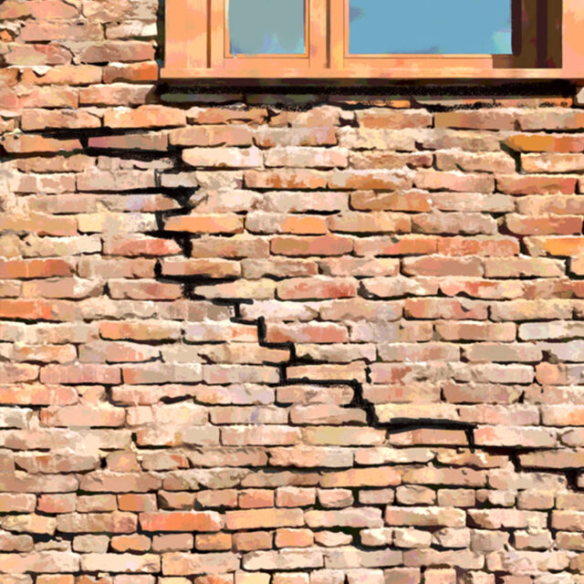 Stepped crack in a brick wall below a window